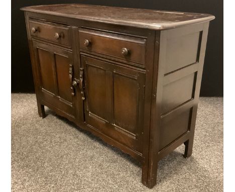 A 1960’s Ercol sideboard, model 331 ‘Old Colonial’, 84.5cm high x 123.5cm wide x 48cm deep. 