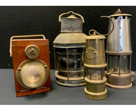 An early to mid 20th torch, wooden case, fall front, large battery interior, unmarked;  an Eccles type 6 miners lamp;  anothe