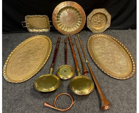 A pair of early 20th century oval brass trays, embossed Ivy leaf and Berries decoration, each measuring 93.5cm x 56.5cm;  a c