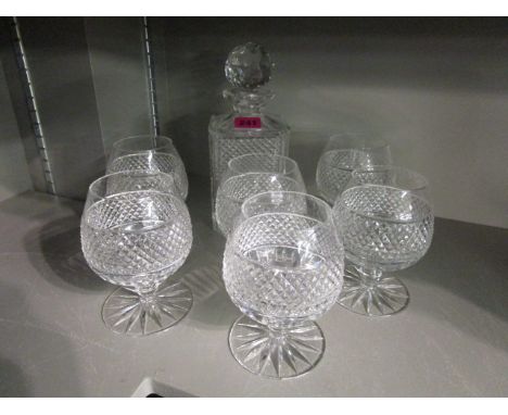 A cut glass whisky decanter and four cut glass matching brandy glasses