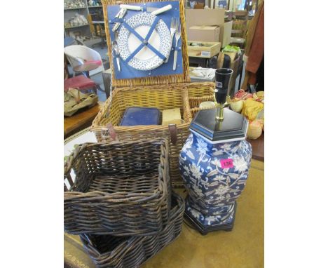 A modern Oriental style table lamp, together with two baskets and a picnic basket