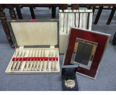 Silver plated pistol grip steak knives and forks, boxes, a silver plated Artemis photo frame and a hip flask