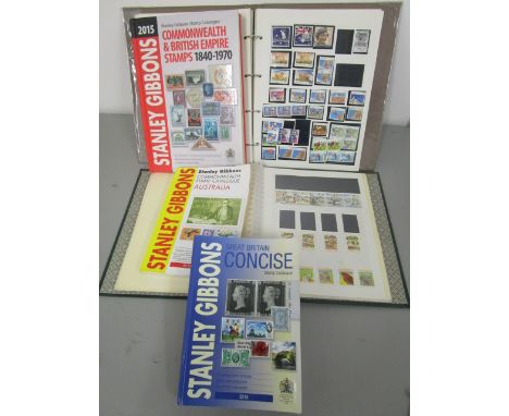 A collection of stamps together with stamp catalogues