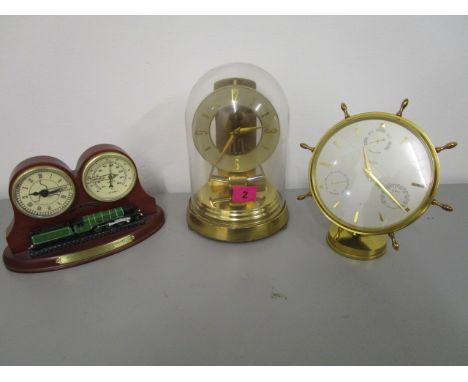 A group of clocks to include an anniversary clock under a dome, an Angelus barometer, and a Hydro and thermometer clock in th