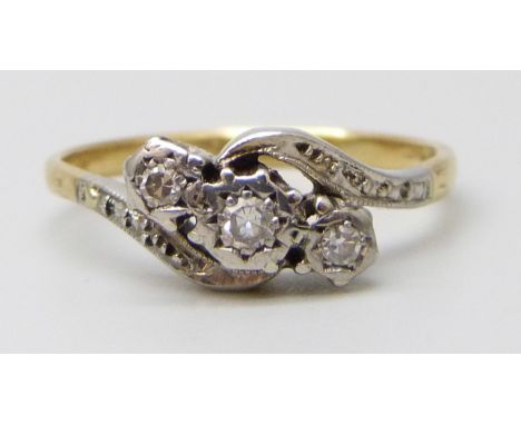 A yellow metal ring set with three diamonds, stamped 18ct, 2.6g, N