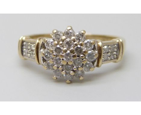 A 9ct gold diamond cluster ring with diamond set shoulders, 2.9g, O