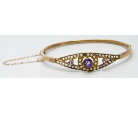A 9ct gold Victorian bangle set with seed pearls and amethyst, a/f, 6.1g, 5.9 x 4.9cm