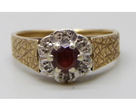 A 9ct gold and diamond cluster ring set with a central garnet, 3.1g, L