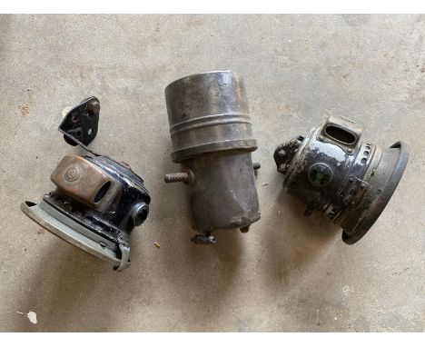 A vintage motorcycle headlamp, generator and sidecar lamp. 