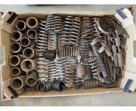 A large tray of springs for vintage motorcycle girder forks and seat frames.
