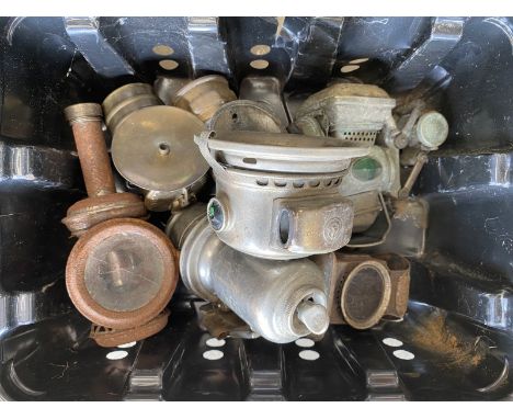 A box of vintage cycle acetylene lamps.