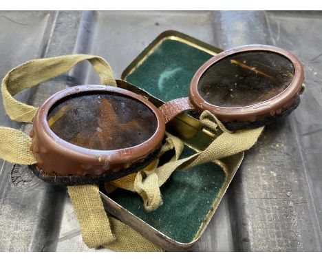 A pair of vintage military motorcycle goggles, in original tin case.