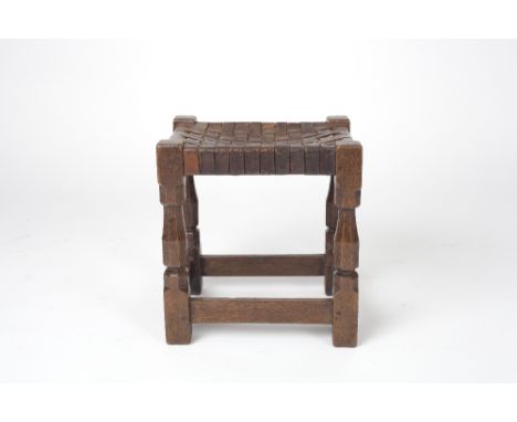 Robert Thompson of Kilburn (British, 1876-1955) Mouseman early stool oak, leather strap top carved mouse 37cm high, 34cm acro