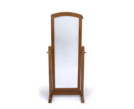 Robert Thompson of Kilburn (British, 1876-1955) Mouseman cheval mirror oak, arched top, with interlinked arch cresting, on oc