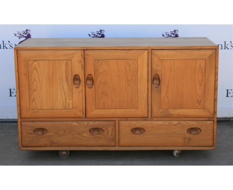 Ercol light elm sideboard, with three cupboard doors over two drawers, on castors, H76 W130 D43 cm