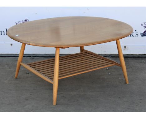 Ercol light elm coffee table, the oval top with turned legs and undertier, H44 W83 L99 cm