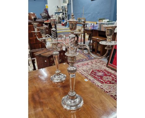 A PAIR OF PLATE ON COPPER THREE LIGHT CANDELABRA, THE CENTRAL LIGHT RAISED ON AN OPEN HELIX.   H 58cms.