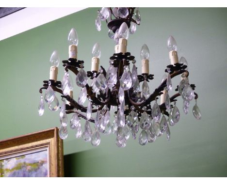 A FOUR AND AN EIGHT LIGHT CANDLE FORM TWO TIER CHANDELIER, EACH HUNG WITH A BEAD ABOVE A PEAR SHAPED DROP