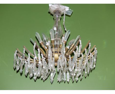 A CHANDELIER WITH LIGHTS ABOVE SICKLE SHAPED ARMS HUNG WITH PRISMATIC DROPS
