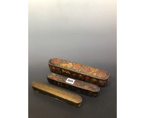 THREE MIDDLE EASTERN LACQUER SCRIBES PEN CASES, TWO PAINTED WITH FLOWERS, THE THIRD WITH GILT FOLIATE DIAPER, THE LARGEST CON