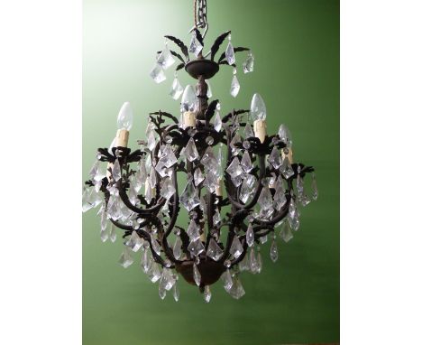 A CHANDELIER ARRANGED WITH EIGHT LIGHTS ABOVE ANOTHER AND HUNG WITH DIAMOND SHAPED DROPS