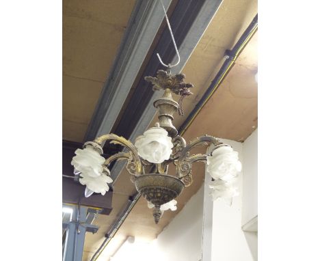 A SIX LIGHT CHANDELIER EACH WITH FROSTED GLASS FLOWER FORM SHADE ON BRASS ARMS FROM THE CENTRAL COLUMN WITH A BOWL SHAPED BAS