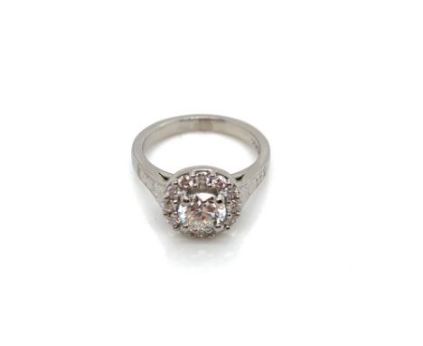 A GIA ROUND BRILLIANT CUT DIAMOND AND PLATINUM RING. THE CENTRE DIAMONDS 0.71cts, SURROUNDED BY A HALO OF 12 FURTHER ROUND BR