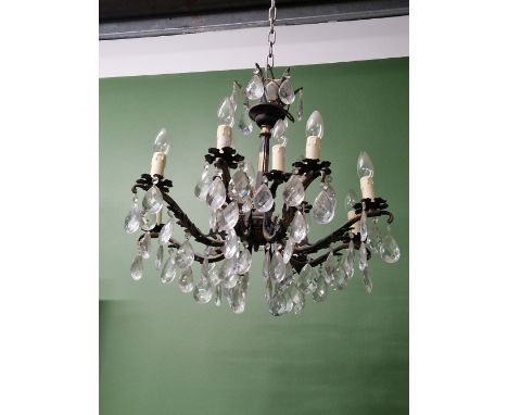 A THREE AND A SIX LIGHT TWO TIER CHANDELIER ON FOLIATE ARMS, EACH LIGHT HUNG WITH A BEAD ABOVE A PEAR SHAPED DROP 