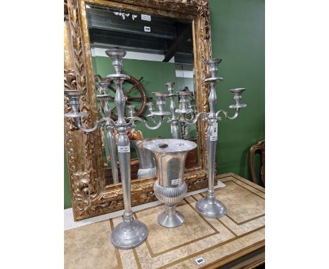A PAIR OF ALUMINIUM THREE LIGHT CANDELABRA. H 79cms. TOGETHER WITH AN ALUMINIUM THISTLE SHAPED VASE ON A CIRCULAR FOOT. H 40c