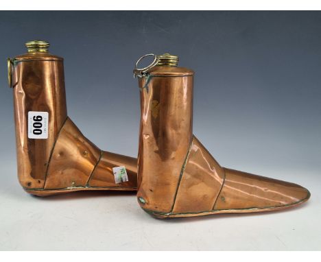 A PAIR OF ARMY AND NAVY COPPER BOOT WARMERS WITH BRASS SCREW TOP CAPS