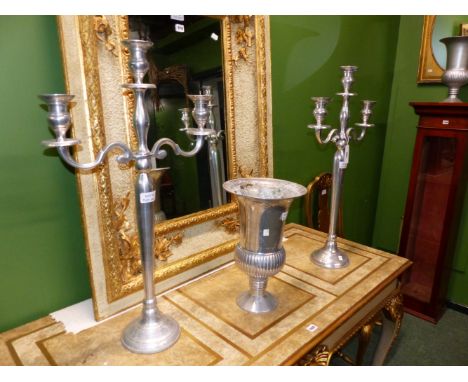 A PAIR OF ALUMINIUM THREE LIGHT CANDELABRA.   H 79cms. TOGETHER WITH A PAIR OF  ALUMINIUM THISTLE SHAPED VASES ON A CIRCULAR 