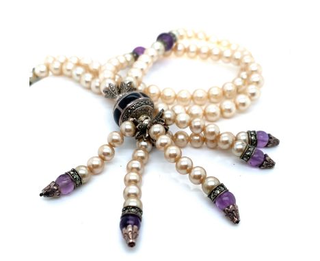 A FAUX PEARL, MARCASITE  AND AMETHYST BEAD NECKLACE. THE CENTRAL PENDANT WITH BLACK ENAMEL AND FIVE ARTICULATING TASSEL DROPS