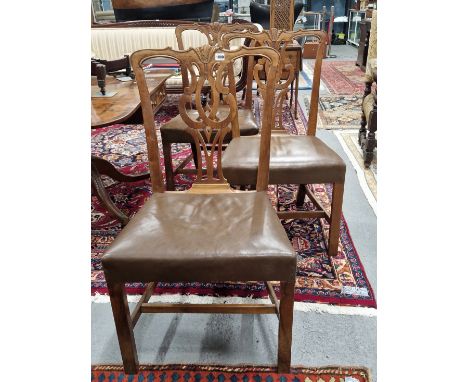A SET OF SIX CHIPPENDALE TASTE WALNUT DINING CHAIRS WITH PIERCED BALUSTER SPLATS, LEATHER SEATS AND SQUARE SECTION FRONT LEGS