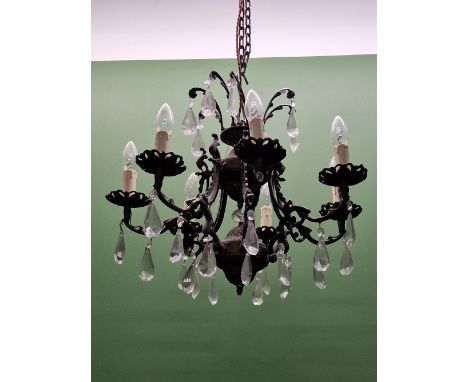 A CHANDELIER WITH THE UPPER TIER HUNG WITH PEAR SHAPED DROPS, THE EIGHT LIGHTS BELOW SIMILARLY HUNG FROM PETAL SHAPE DRIP PAN