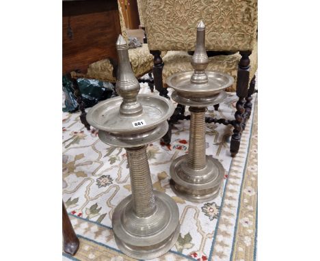 A PAIR OF SILVERED METAL PRICKET CANDLESTICKS WITH DISHED DRIP PANS AND CIRCULAR FEET, THE COLUMNS RING TURNED.   H 68cms