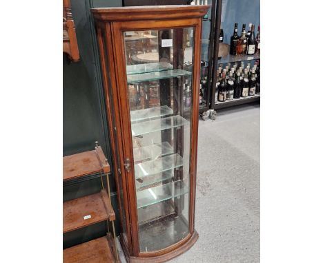 AN EARLY 20th C. BOW FRONT GLAZED MAHOGANY DISPLAY CABINET.   W 30 x D 23.5 x H 107cms.