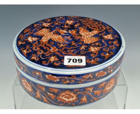 A CHINESE IRON RED AND UNDERGLAZE BLUE WRITING BOX AND COVER, THE CIRCULAR LID OPENING ONTO A CENTRAL PAD FOR MIXING THE POWD