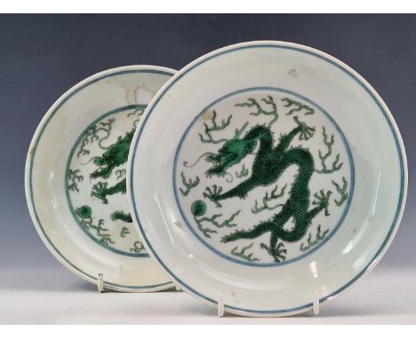 A PAIR OF CHINESE SHALLOW BOWLS PAINTED IN GREEN CENTRALLY WITH DRAGONS CHASING FLAMING PEARLS, SEAL MARKS IN UNDERGLAZE BLUE