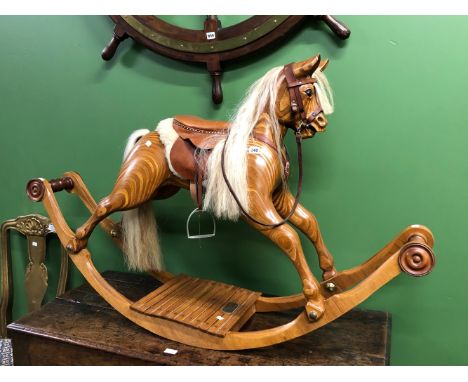A WAYSIDE ROCKERS OF EVESHAM ROCKING HORSE CARVED FROM BONDED SLICES OF DARK AND LIGHT WOOD, THE HARNESSED HORSE WITH A WHITE