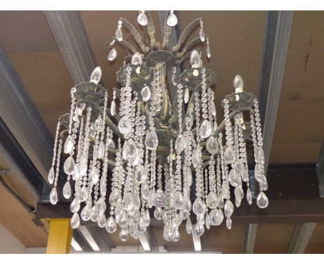 A TWO TIER CHANDELIER, THE LOWER TIER WITH TEN LIGHTS HUNG WITH PEAR SHAPED DROPS FROM STRINGS OF GLASS BEADS