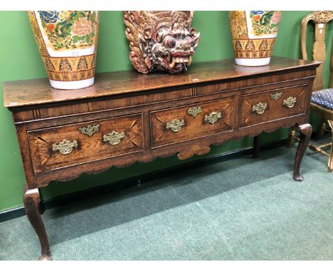 A GEORGIAN AND LATER&nbsp; OAK DRESSER, THE PLANK TOP OVER THREE DRAWERS INLAID IN HOLLY AND EBONY ARROW SHAPES AT THE CORNER