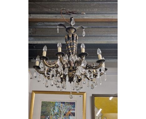 A GILT METAL TWO TIER CHANDELIER, THE FOLIATE SUPPORTING COLUMN ENDING IN A BOWL SHAPE MOUNTED WITH MASKS WITH TEN ARMS SCROL