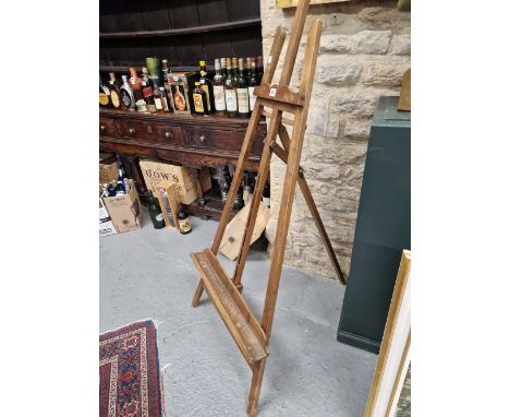 A VICTORIAN MAHOGANY ARTISTS EASEL, THE PICTURE RESTING TROUGH.   W 52cms.