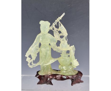 A CHINESE BOWENITE CARVING, WOOD STAND AND FITTED BOX, THE TRANSLUCENT GREEN STONE CARVED AS A LADY WITH TWO FISH ON HER ROD 