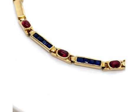 A SAPPHIRE AND RUBY SET PANEL BRACELET. THE BRACELET UNHALLMARKED, STAMPED 585, ASSESSED AS 14ct GOLD. LENGTH 18.5cms. WEIGHT