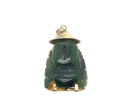A NEPHRITE JADE CARVED BUDDHA PENDANT FITTED WITH A GOLD PLATED COVER WITH CHARACTER MARKS AND EASTERN HAT WITH PENDANT BAIL.