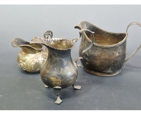 A GEORGE III SILVER CREAM JUG, TWO OTHERS, A PAIR OF FIDDLE PATTERN TABLE SPOONS, A FIDDLE THREAD AND SHELL SAUCE LADLE, A DE