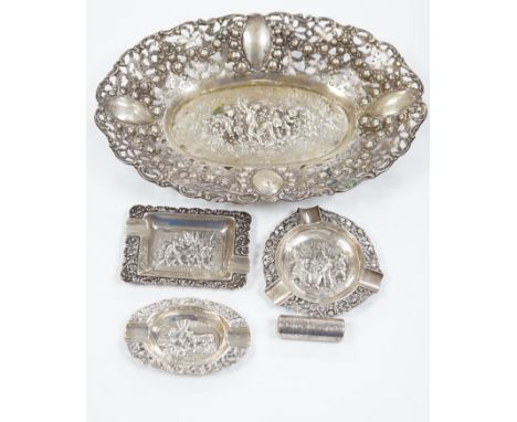 A German pierced 800 white metal oval dish, 28.4cm, three Dutch white metal ashtrays and an 835 white metal lighter.