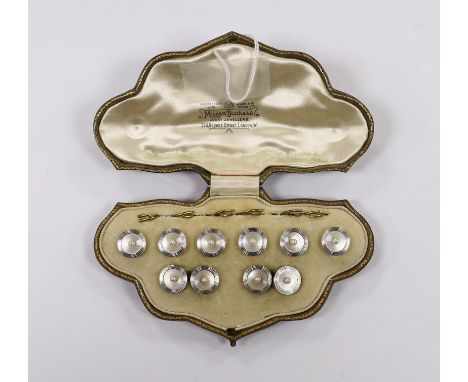 An early to mid 20th century 18ct, mother of pearl and seed pearl set eight piece dress stud set, including pair of cufflinks