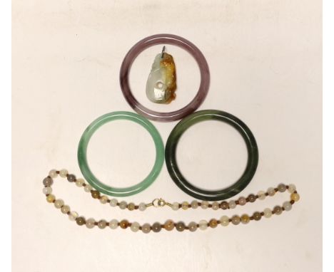 Two Chinese jade bangles, another, a jade pendant and beads